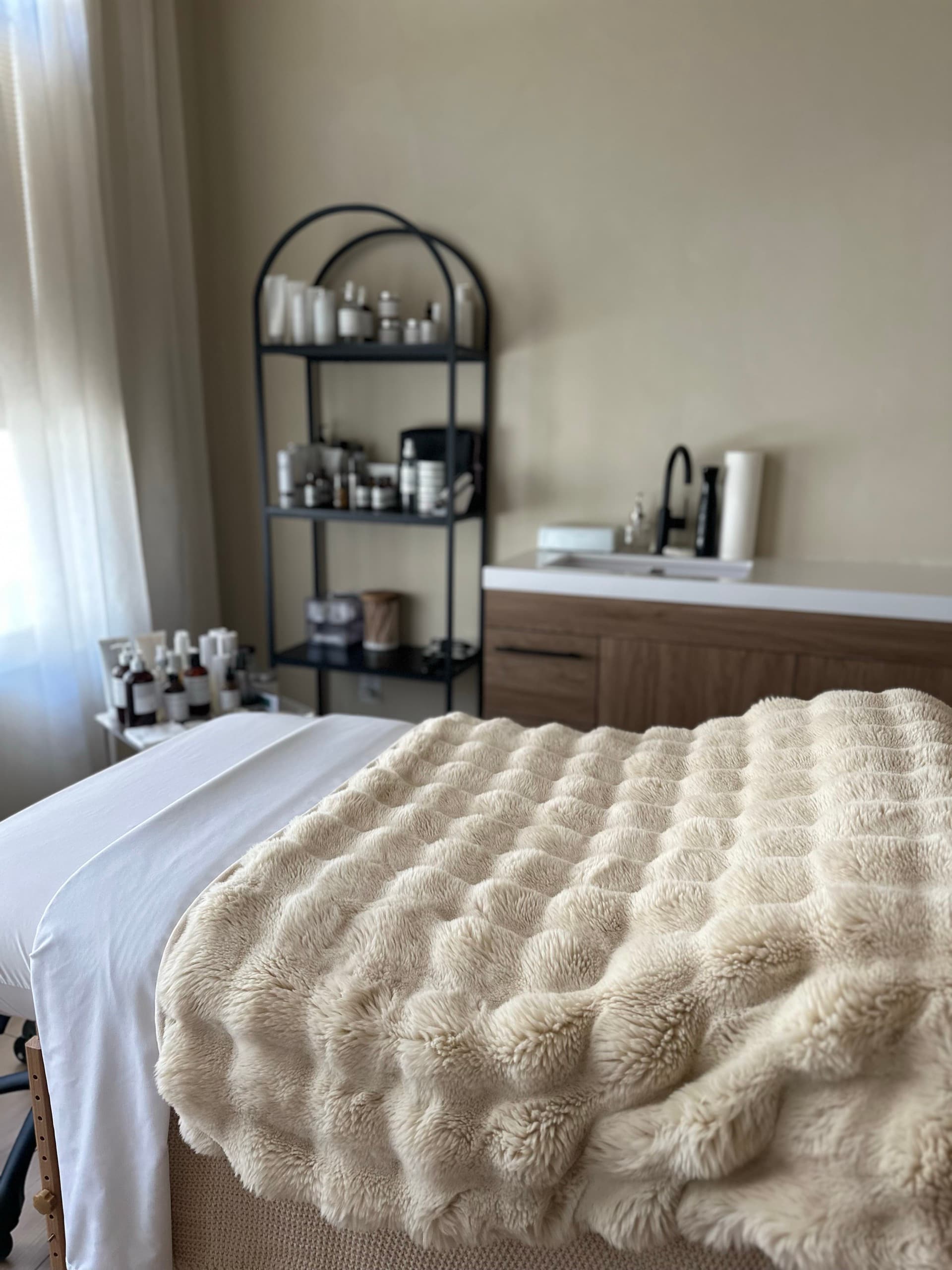 A serene treatment room with warm lighting and clean linens